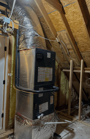 HVAC unit installed in attic space.